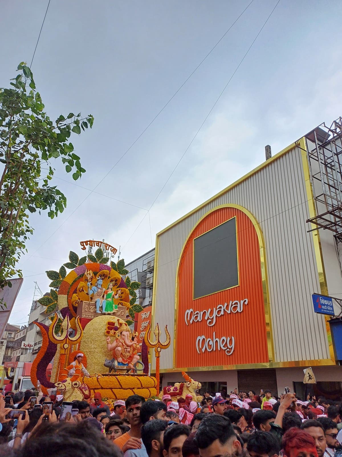 Guruji Talim Ganpati visarjan miravnuk moving through a packed street